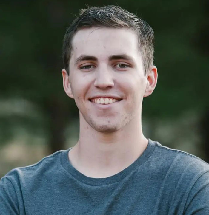 Young man smiling outdoors, representing Tyler Robinson's trans partner disappearance and neighbors breaking silence. Young man smiling outdoors, representing Tyler Robinson's trans partner disappearance and neighbors breaking silence.