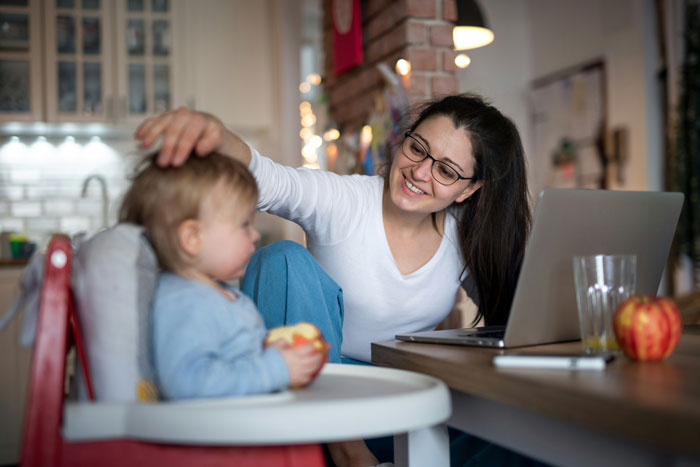Woman smiling and interacting with toddler at home, highlighting tension in relationship where man hates her ease. Woman smiling and interacting with toddler at home, highlighting tension in relationship where man hates her ease.