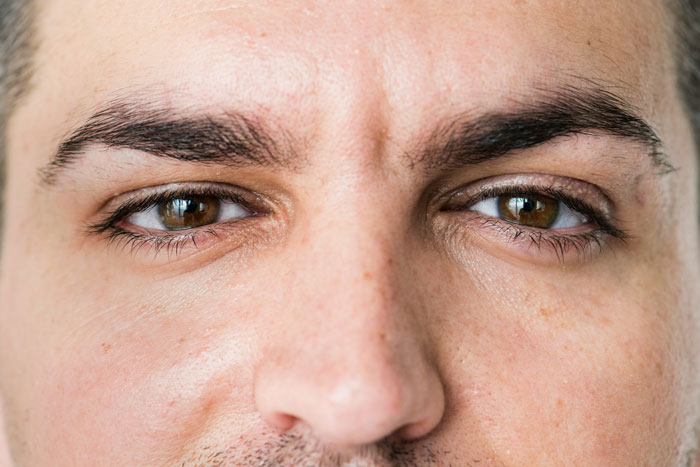 Close-up of a professor's face showing expressive eyes, capturing the essence of professors who left an impression on students.