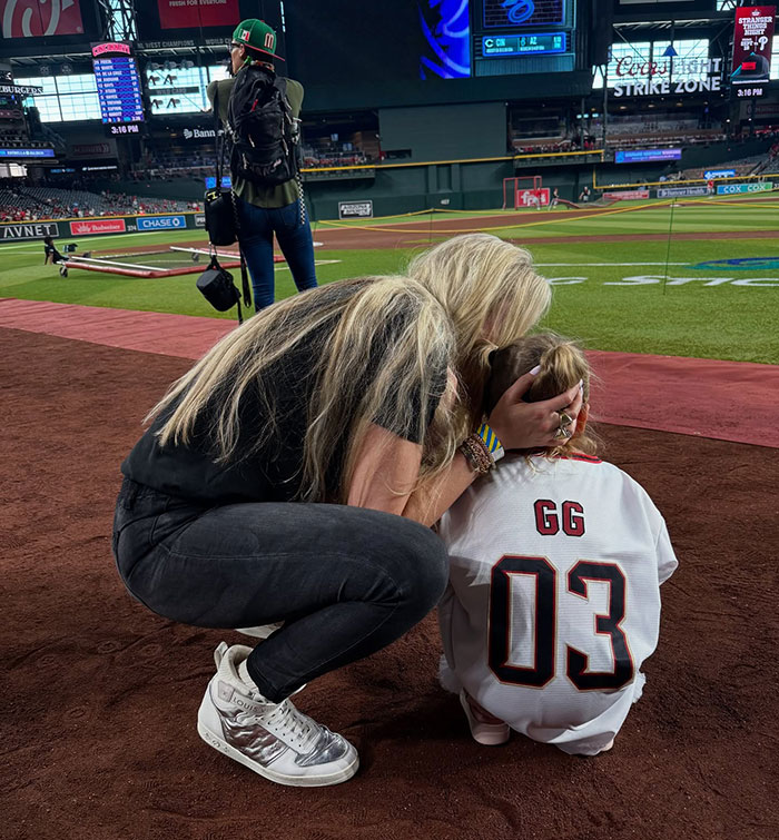 Charlie Kirk's wife comforting child on baseball field, sharing a haunting post before fatal attack incident.