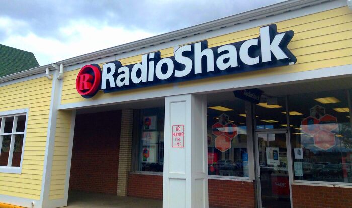 RadioShack storefront with yellow siding, showcasing a retail example of the next big thing that totally flopped.