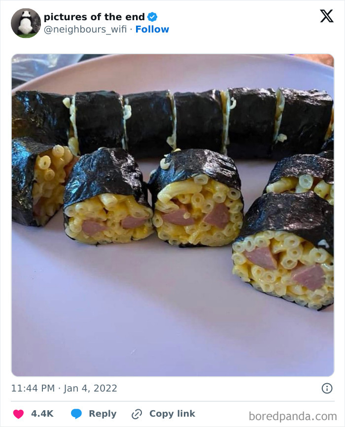 Macaroni and sausage wrapped in seaweed resembling sushi in a weird and blessed cursed photo.