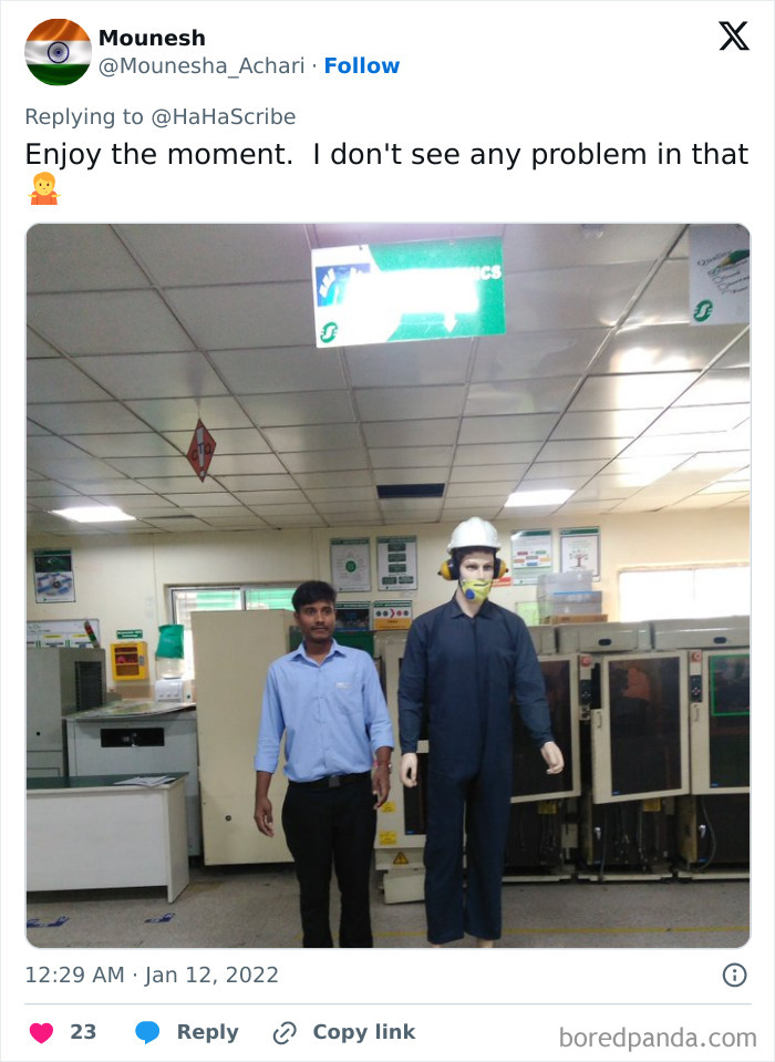 Man standing next to a lifelike mannequin in safety gear inside an industrial room showing life imitating art concept.