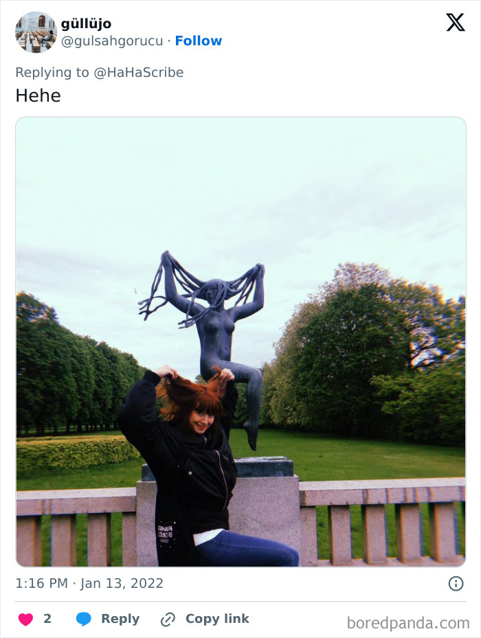 Person humorously imitating iconic art statue by posing with hair in a park setting, showcasing creative and hilarious art imitation.