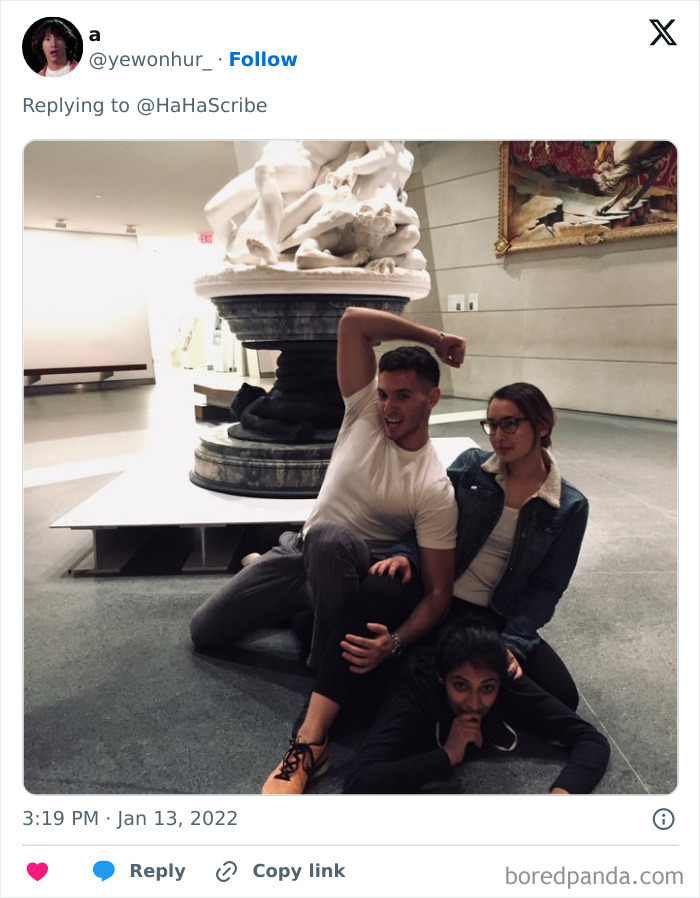Three people creatively pose on the floor in a museum, imitating an iconic art sculpture with playful expressions.