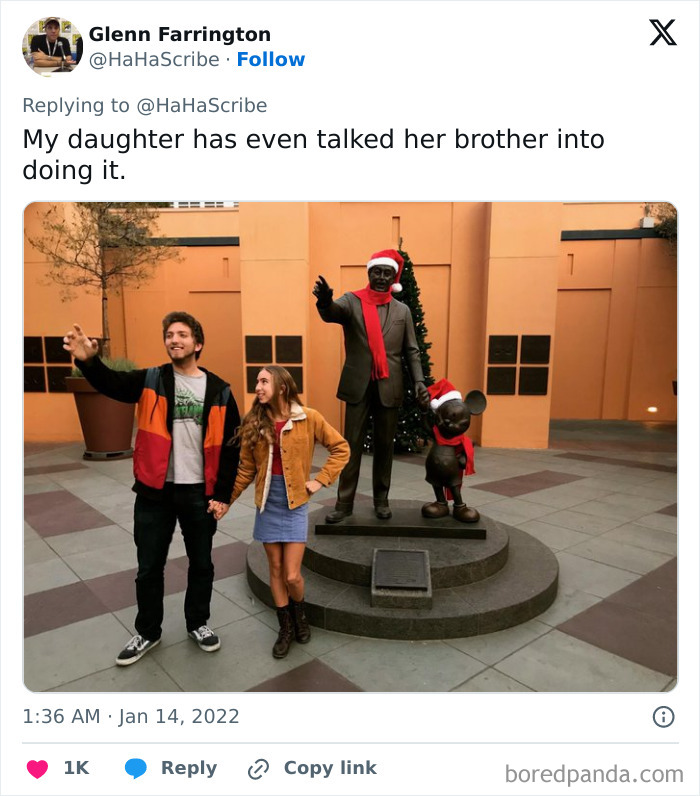 A young woman and man posing next to a festive statue, showcasing life imitating art with holiday-themed decorations.