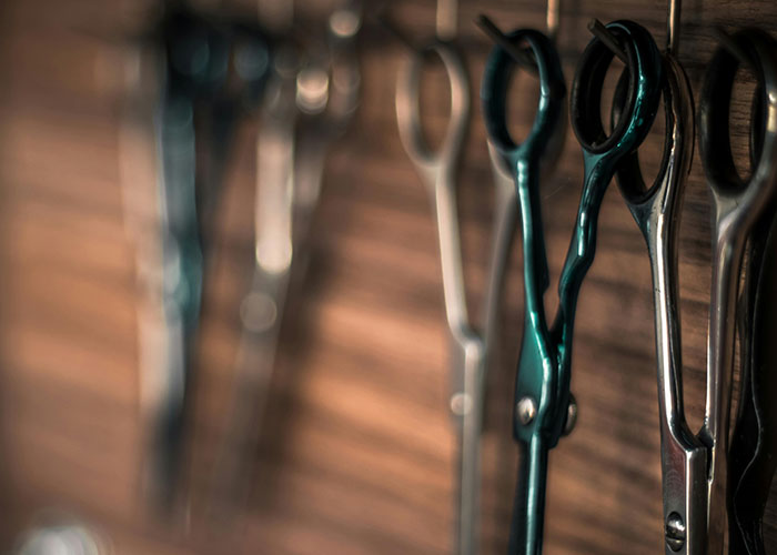 Close-up of vintage scissors hanging on a wooden wall showing hidden gems discovered after moving into new homes.