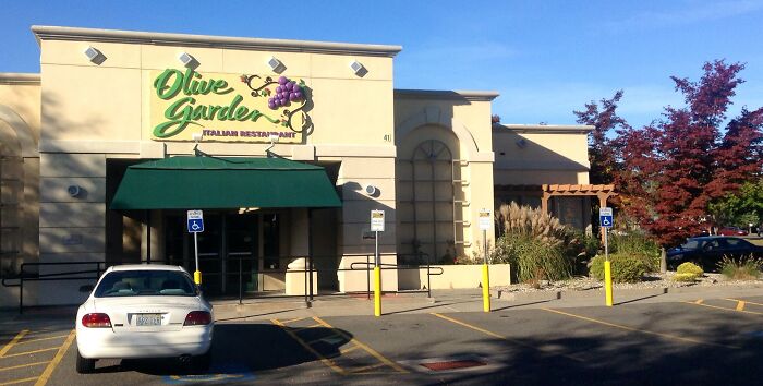 Olive Garden restaurant exterior with parking lot, related to crazy stories servers overheard in the dining industry.