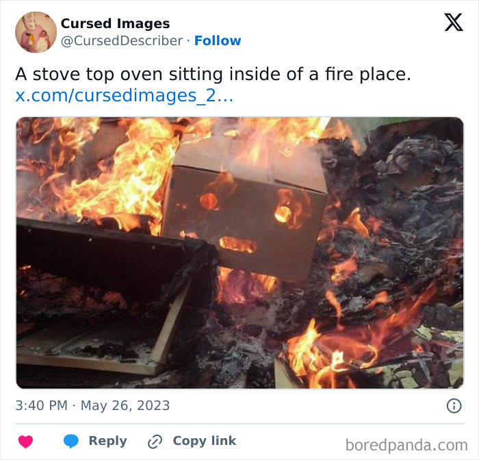A disturbing picture of a stove top oven burning inside a fireplace surrounded by intense flames and smoke.