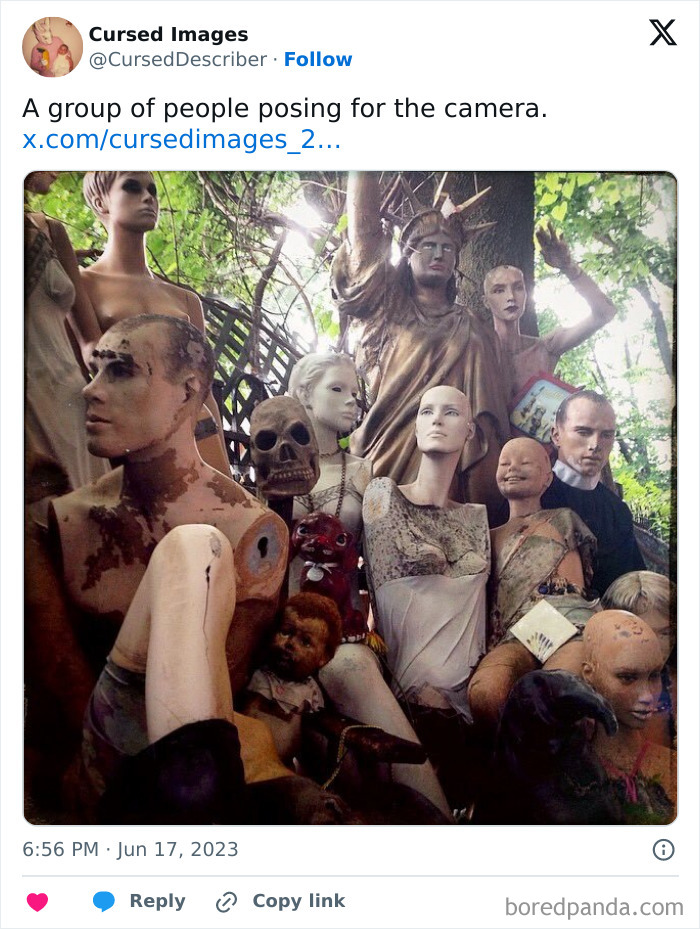 A disturbing group of worn and damaged mannequins and dolls arranged eerily in an outdoor setting.
