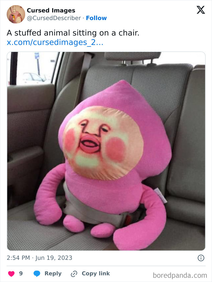 Stuffed animal with a distorted human-like face buckled in a car seat, a disturbing cursed image.