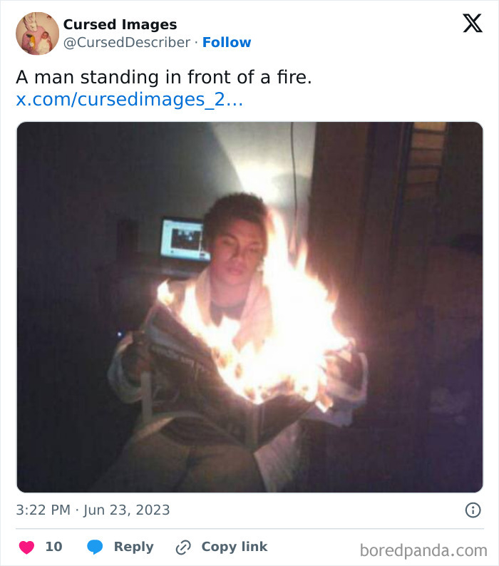 A man holding a burning newspaper indoors, creating a disturbing and cursed image effect.