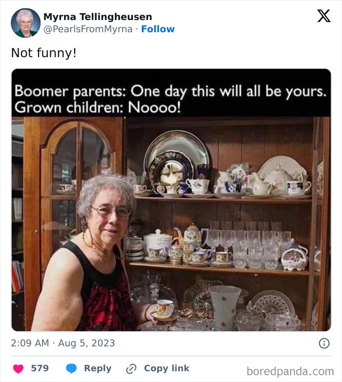 Elderly woman holding a teacup in front of a china cabinet, showcasing the internet’s funniest grandma humor.