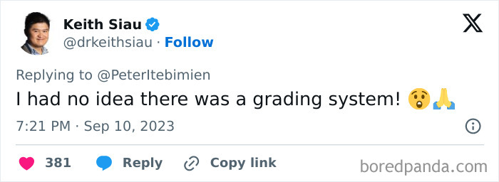 Man in blue shirt and glasses replying on Twitter about a grading system, related to Beckham dangerous sign on body.