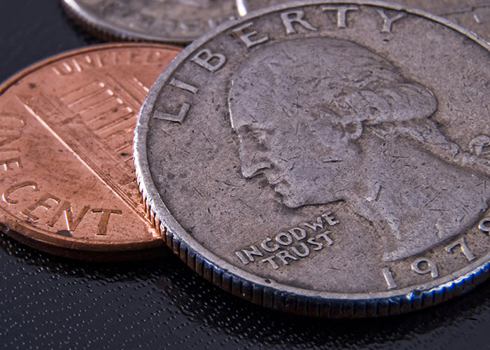 Close-up of a 1979 quarter and a penny, showcasing a hidden gem discovered after moving into a new home.