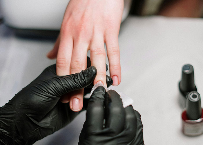 Close-up of a manicure in progress, showing nail care as a common purchase people have ditched due to price.