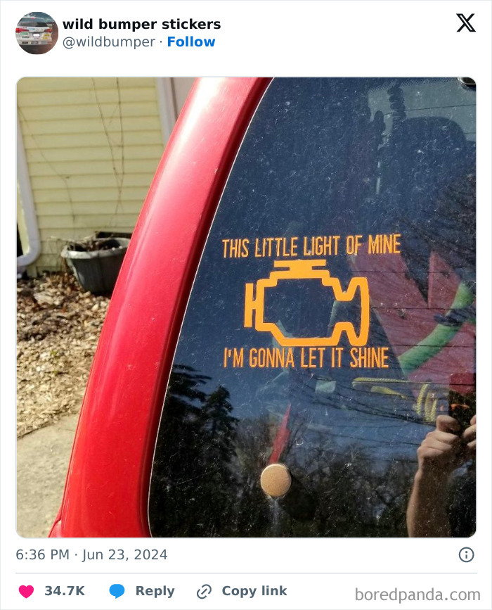 Bumper sticker on a red car window showing an engine warning light with a humorous phrase about letting it shine.