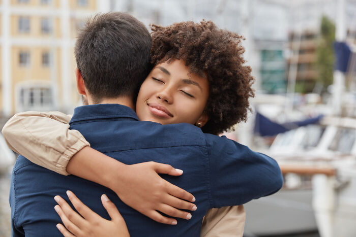 Two people sharing a warm hug outdoors, expressing the life-changing sentences that touch hearts deeply.