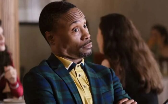 Man in a plaid jacket and yellow shirt showing a surprised expression, capturing a moment meeting an idol.