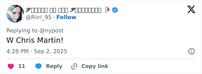 User profile picture showing a person with dark hair and makeup, replying to a tweet about Coldplay&rsquo;s Chris Martin.