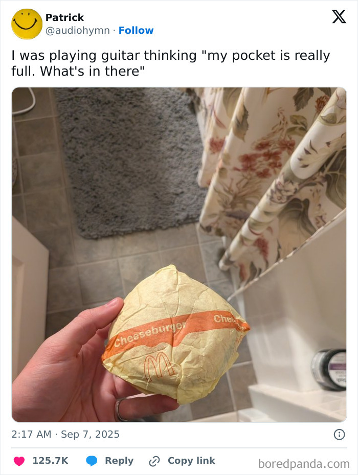 Funny tweet showing a person holding a wrapped McDonald's cheeseburger, part of funniest tweets of September collection.