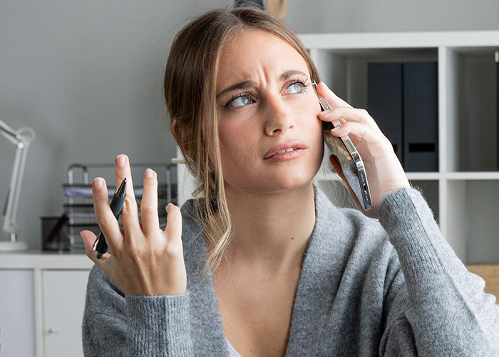 Woman showing frustration while on phone call, illustrating weaponized incompetence and inability to complete simple tasks. Woman showing frustration while on phone call, illustrating weaponized incompetence and inability to complete simple tasks.
