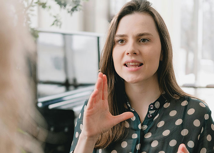 Woman expressing frustration while discussing with children about Easter gifts and keeping daughters in line.