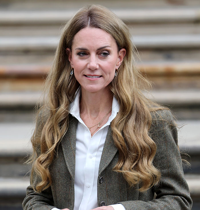Kate Middleton with long blonde hair in a white shirt and jacket outside, addressing trolls criticizing her hair color. Kate Middleton with long blonde hair in a white shirt and jacket outside, addressing trolls criticizing her hair color.