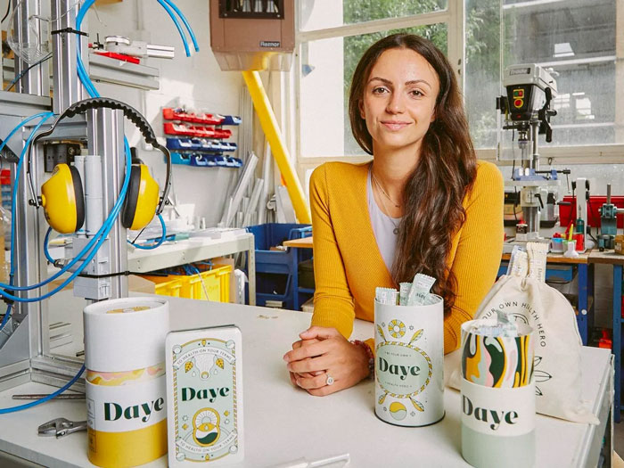 Woman in a yellow sweater in a workshop showcasing Daye products related to hair and teeth growth inside a 9-year-old girl.