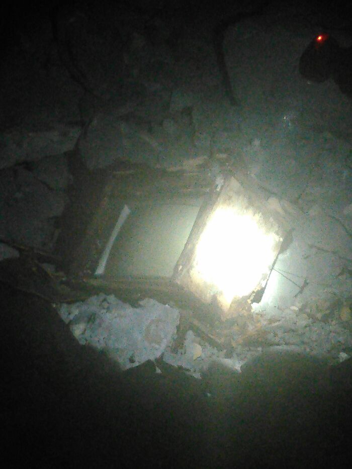 Dimly lit underground tunnel with debris and a partially collapsed structure, capturing terrifying true stories of explorers beneath our feet.