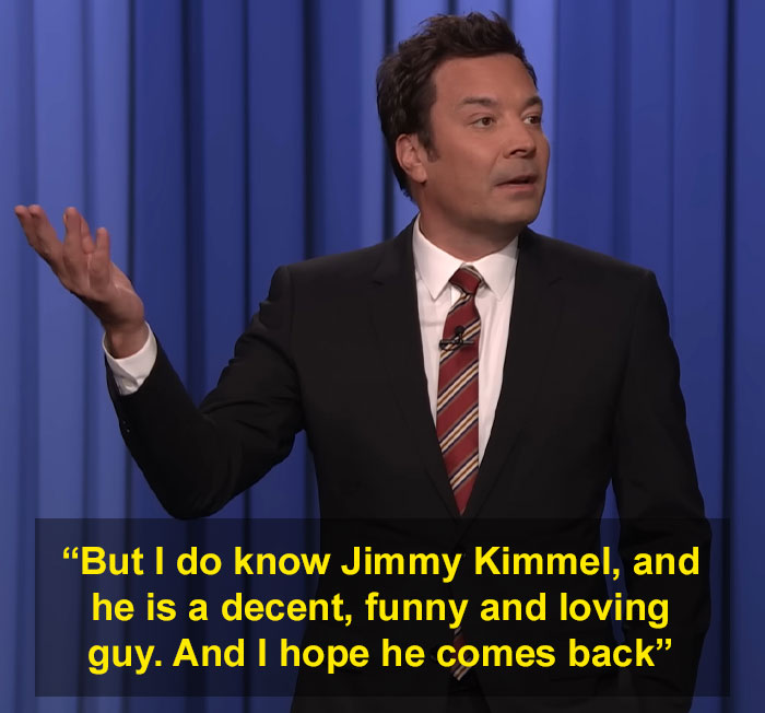 Jimmy Fallon speaking on stage in a suit and striped tie, addressing Jimmy Kimmel's show suspension with a hopeful tone.