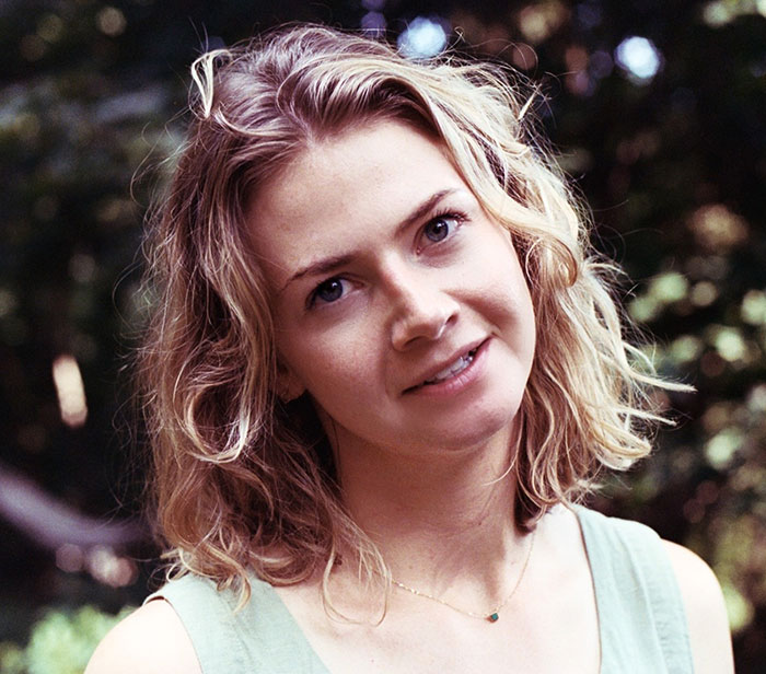 Young woman with blonde hair outdoors, representing Brooklyn midwife&rsquo;s dice game club and safety concerns for non-white women.