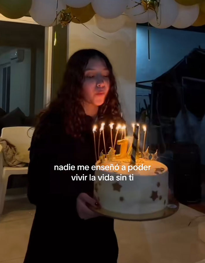 Teen girl blowing out candles on birthday cake indoors, related to doctor suspended after fatal breast surgery case. Teen girl blowing out candles on birthday cake indoors, related to doctor suspended after fatal breast surgery case.