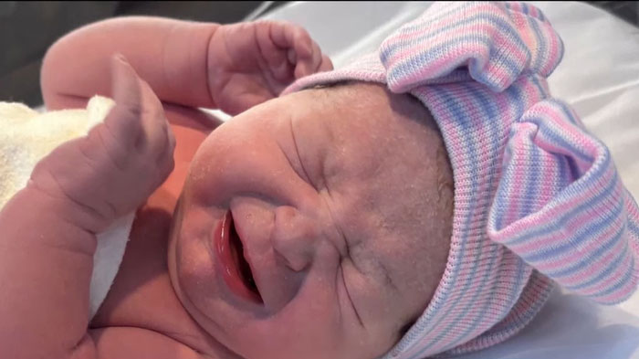 Newborn baby moments after delivery, highlighting a woman who didn't know she was pregnant until childbirth.