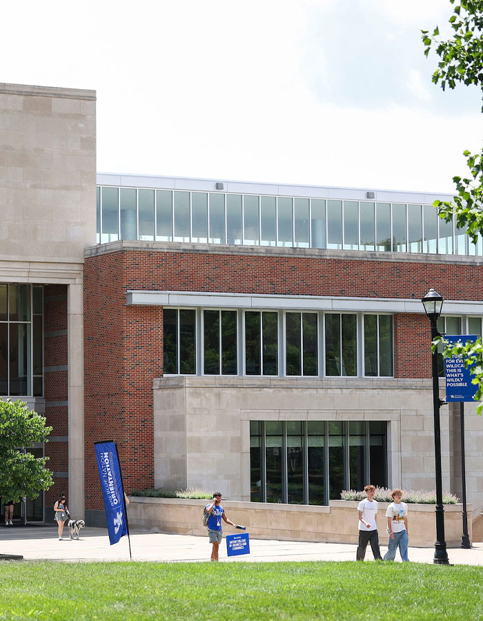 University campus with students walking and holding signs, related to disturbing newborn baby case news.