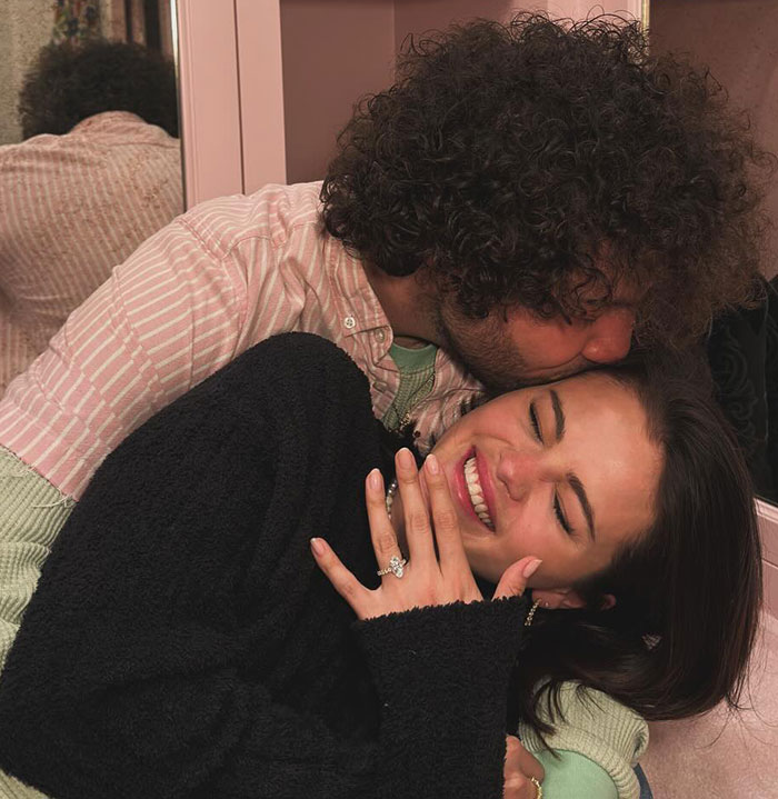 Couple embracing closely, showcasing unique and quirky outfits at Selena Gomez and Billy Blanco&rsquo;s star-studded wedding event.