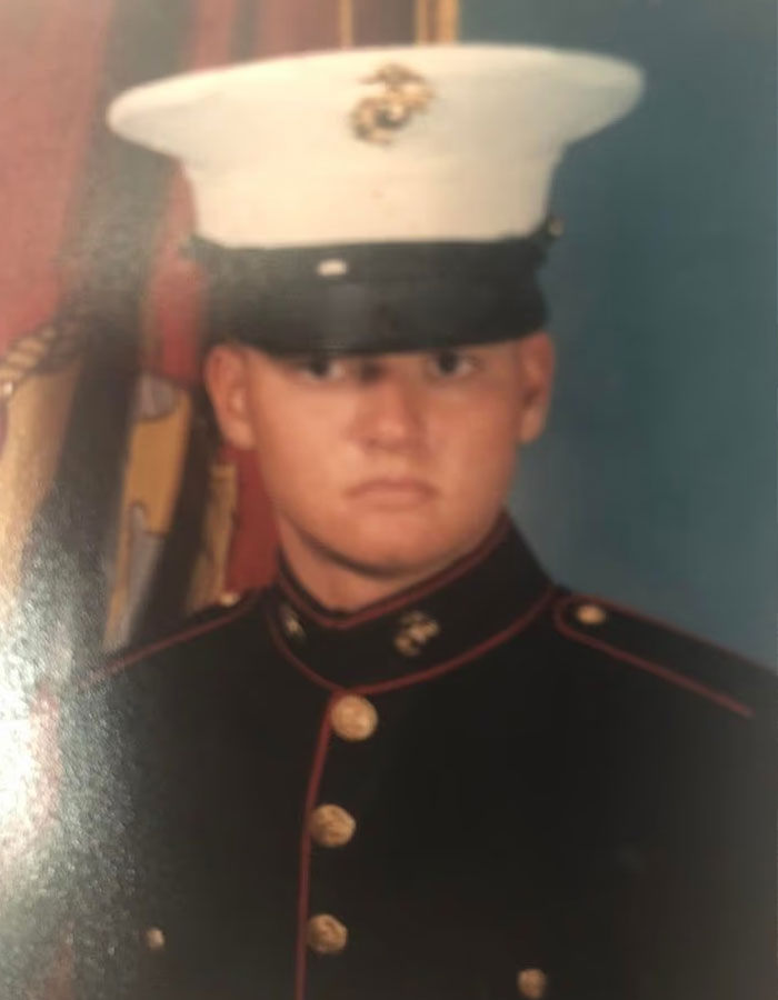 Young man in military dress uniform with white hat, related to Michigan suspect's eerie confession before church attack.