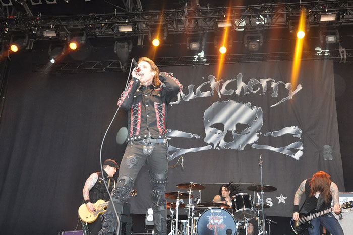 Live concert photo of a rock band performing with intense energy and fans sharing concerts they wish they’d skipped.