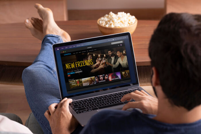 Person watching a movie on a laptop, illustrating real-life stories of people becoming the very thing they once hated.