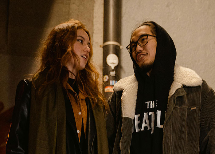 Two people having a casual conversation outdoors at night, illustrating coincidences that are incredible but true.