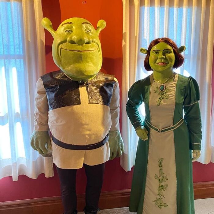 Wax sculptures of famous figures dressed as Shrek and Fiona with a surprisingly creepy and hilarious look indoors.