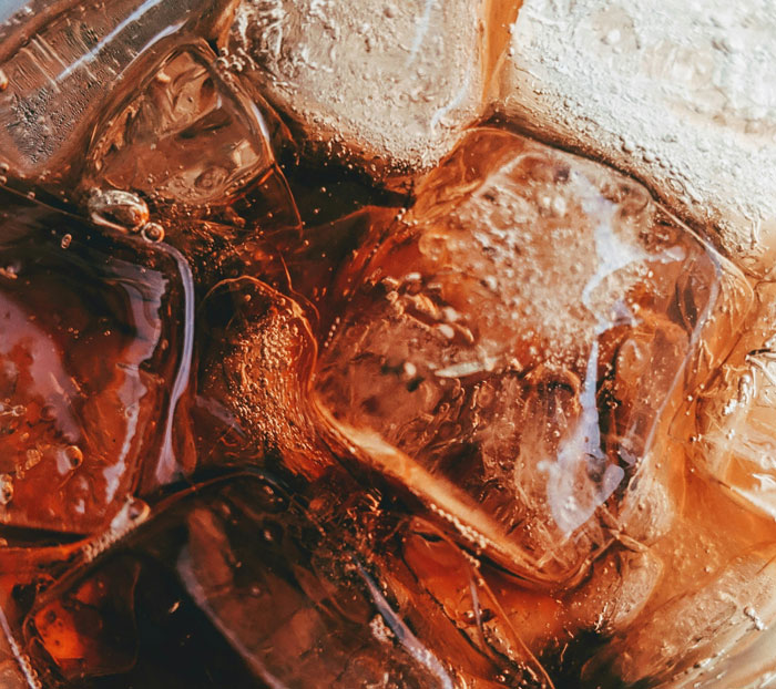 Close-up of ice cubes melting in a cold drink, illustrating one of the brilliant loopholes people exploited to save money.