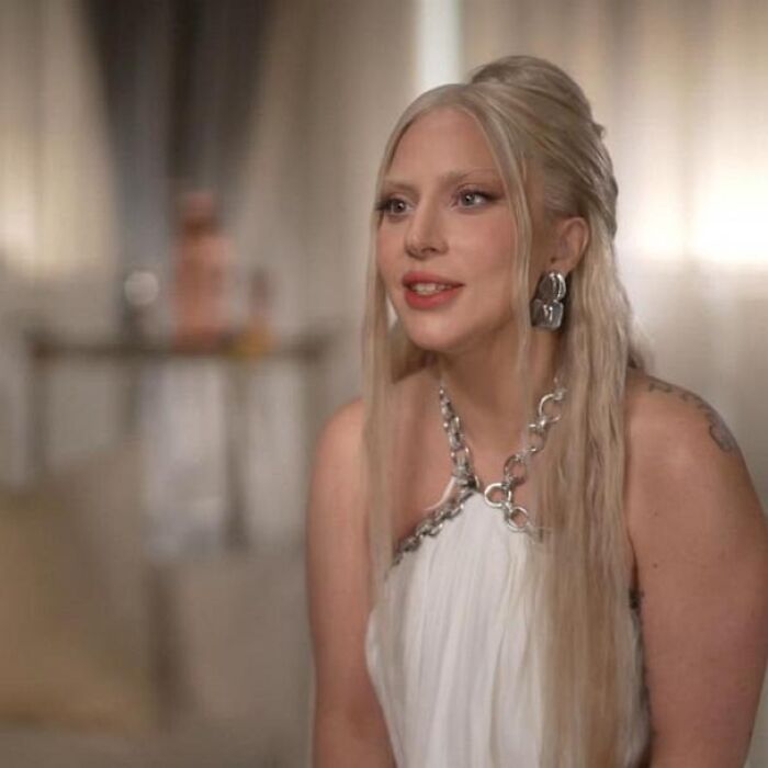 Woman with long blonde hair and silver jewelry smiling during an interview about meeting an idol experiences.