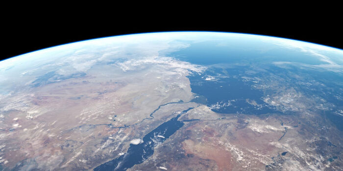 View of Earth's surface from space showing land, water, and cloud formations, illustrating surfing online discoveries.