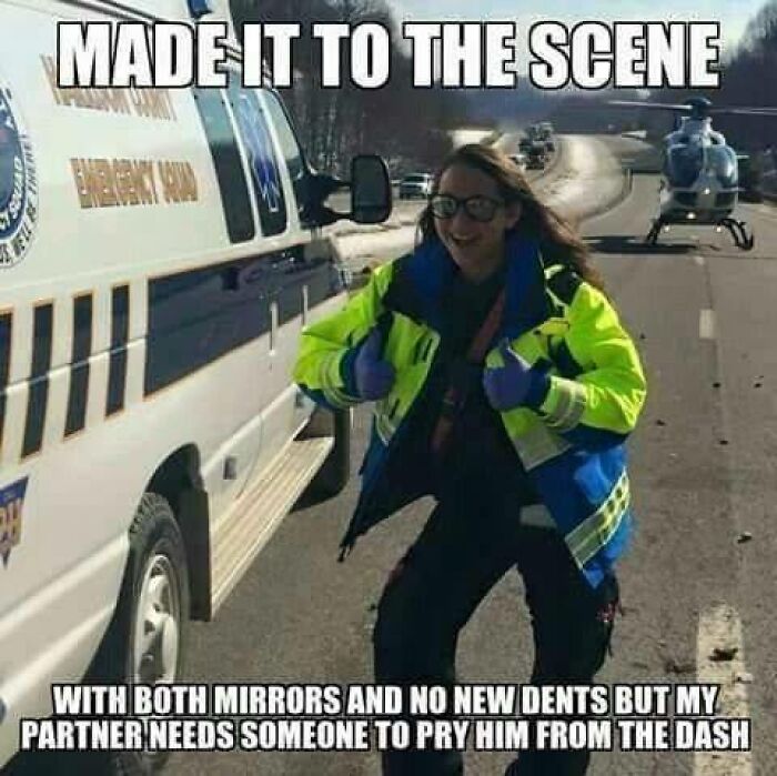 Female EMT in reflective jacket giving thumbs up near ambulance and helicopter, capturing EMT and paramedic humor meme.