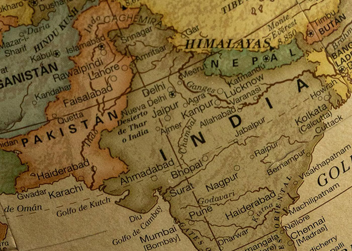 Vintage map showing India, Pakistan, and surrounding regions highlighting historical events impacting society and damage.
