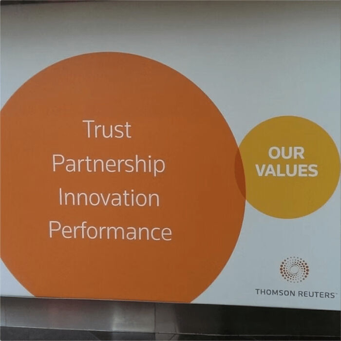 Corporate values displayed on wall with Trust, Partnership, Innovation, Performance, linked to social media company failures.