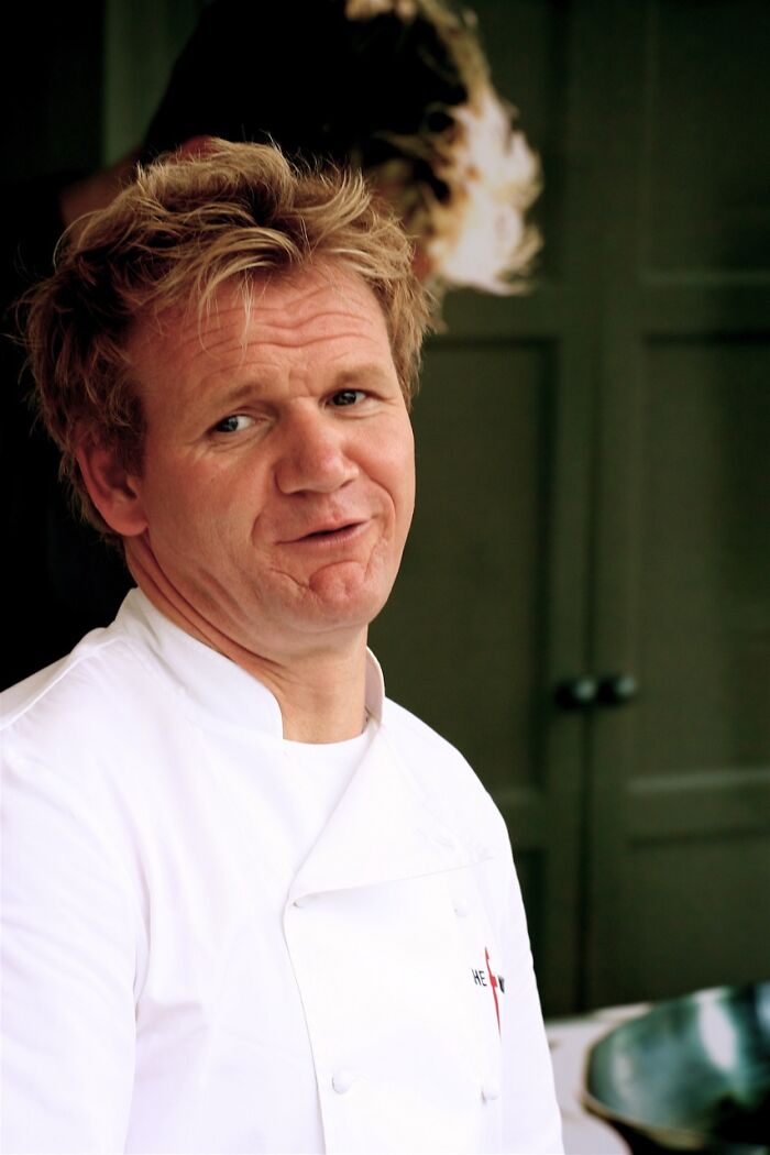 Chef Gordon Ramsay in a white jacket, captured in a candid moment, related to people running into celebrities.