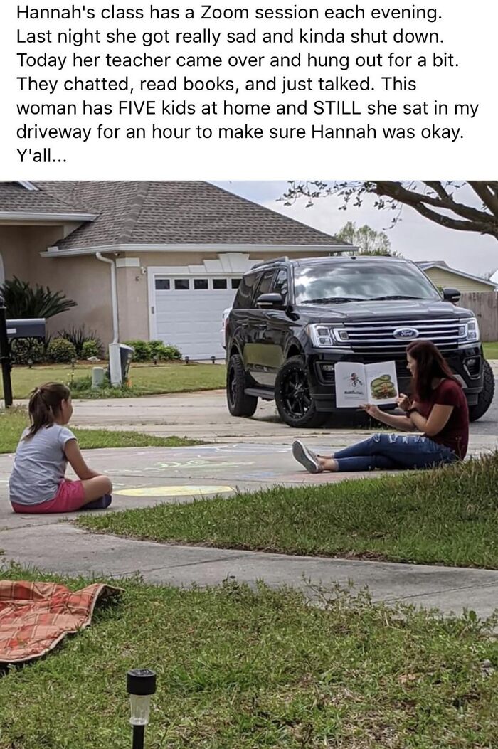Teacher reading a book outside with a child to provide comfort, a wholesome post to distract from the world’s current horrors.
