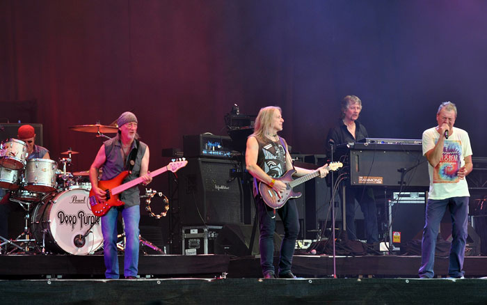 Deep Purple performing live on stage during a concert fans wish they had skipped due to band tensions and conflicts.